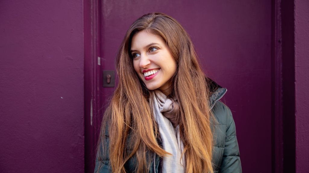 smilling woman purple background