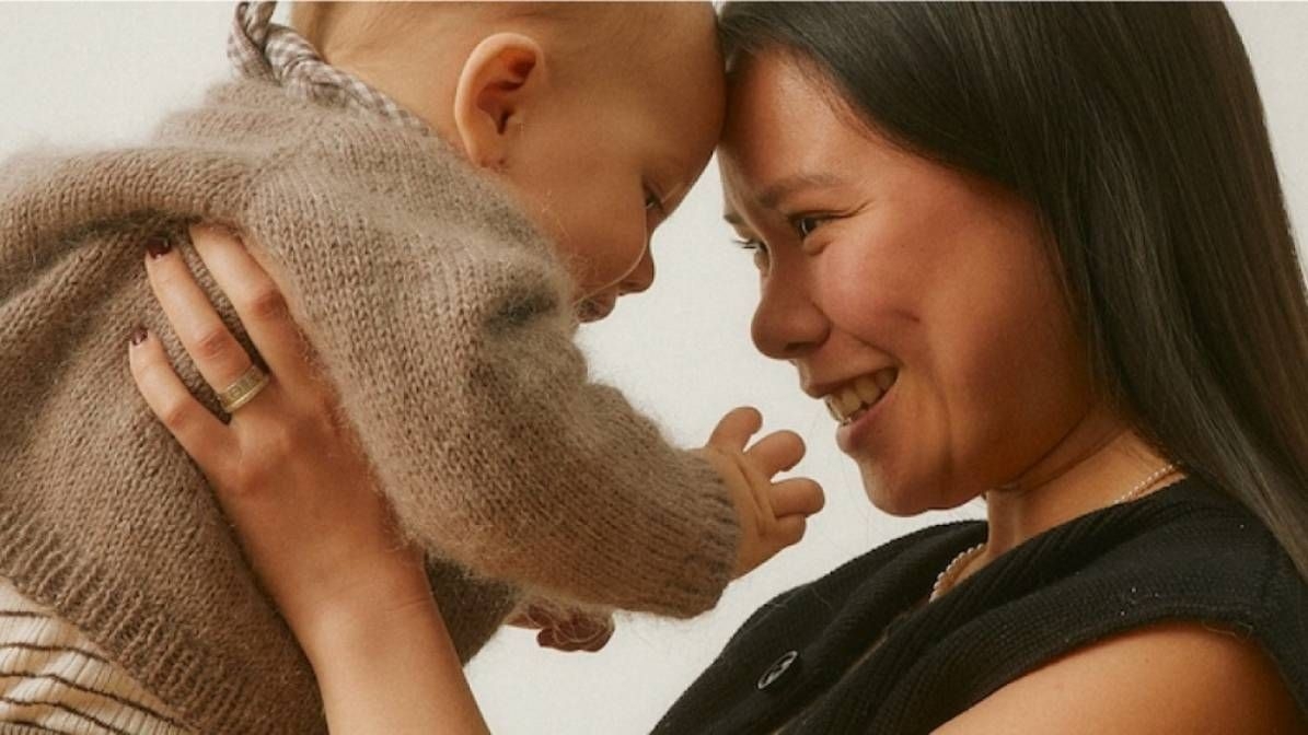 mum holding happy baby