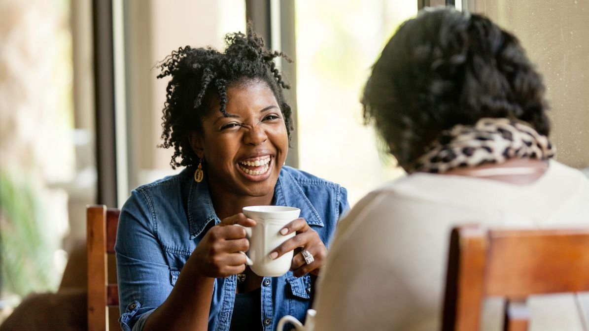 two woman talking at a coffe shop